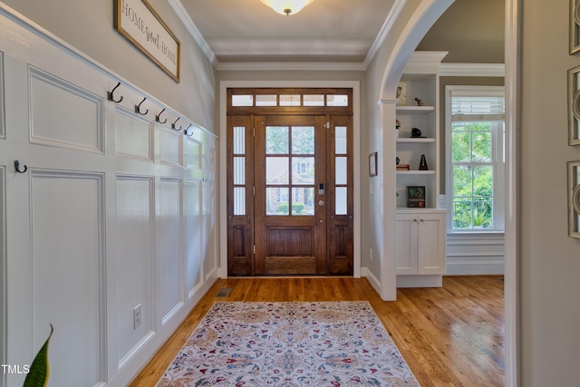1161 Golden Star Way, Wake Forest, NC 27587 - foyer entrance with light wood-style floors, ornamental molding, and arched walkways