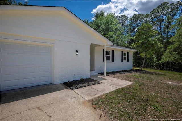 6263 Stoney Point Loop, Fayetteville, NC 28306 - property entrance featuring driveway, brick siding, and a garage