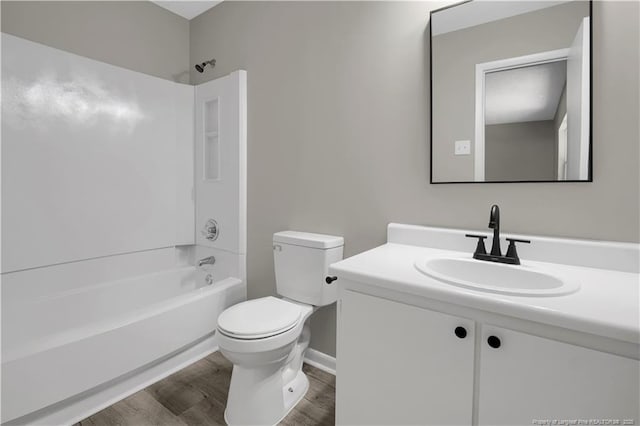 6263 Stoney Point Loop, Fayetteville, NC 28306 - full bath featuring wood finished floors, vanity, toilet, tub / shower combination, and baseboards