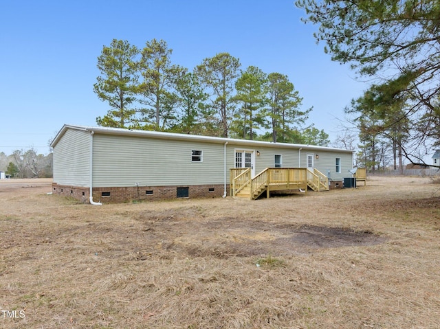 752 Dundee Cir, Raeford, NC 28376 - rear view of house with crawl space and a wooden deck