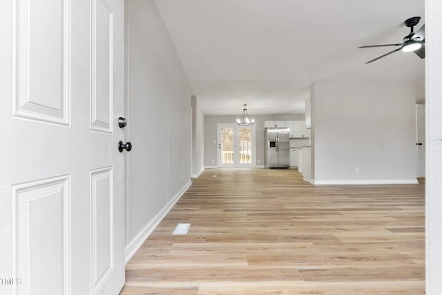 752 Dundee Cir, Raeford, NC 28376 - unfurnished living room featuring a ceiling fan, a chandelier, light wood-style floors, and baseboards