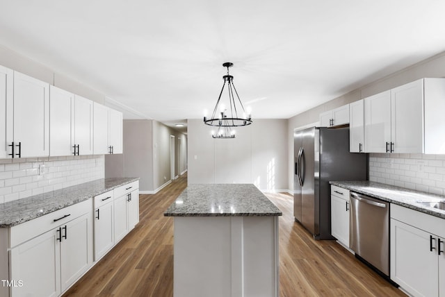 752 Dundee Cir, Raeford, NC 28376 - kitchen with stainless steel appliances, a kitchen island, backsplash, and white cabinets