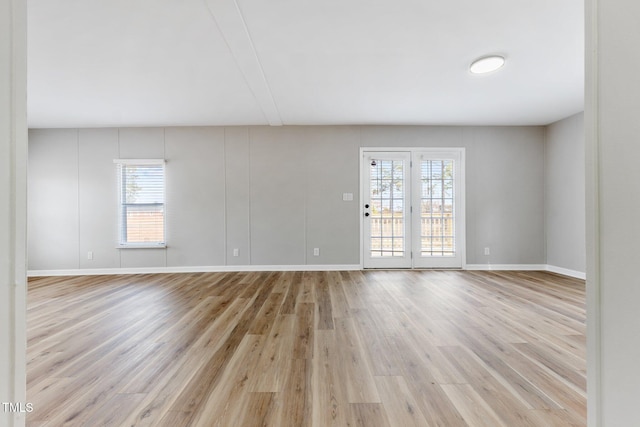 752 Dundee Cir, Raeford, NC 28376 - spare room featuring plenty of natural light, light wood-type flooring, and baseboards
