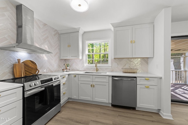 216 Burkwood Ln, Raleigh, NC 27609 - kitchen featuring wall chimney range hood, stainless steel appliances, a sink, and light countertops