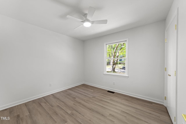 216 Burkwood Ln, Raleigh, NC 27609 - unfurnished room with wood finished floors, a ceiling fan, and baseboards