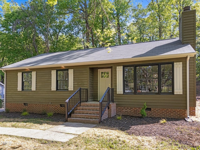 216 Burkwood Ln, Raleigh, NC 27609 - view of front facade with crawl space, a chimney, and roof with shingles