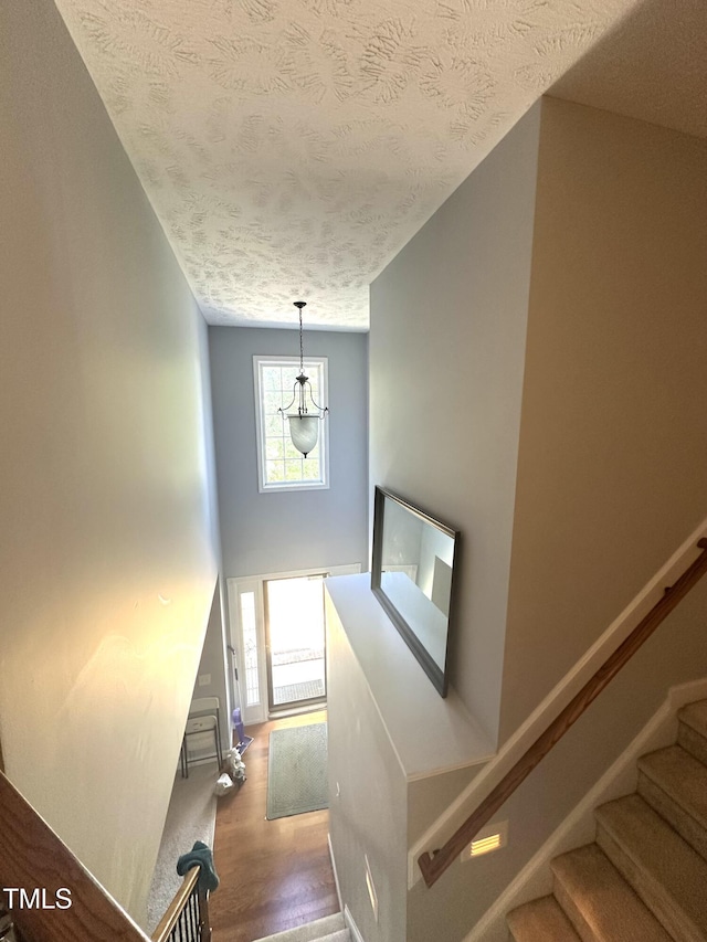 75 Mountainside Ln, Sanford, NC 27332 - stairs with a textured ceiling, baseboards, and wood finished floors
