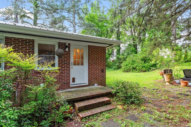 7 Woodward Way, Chapel Hill, NC 27516 - view of exterior entry with brick siding and metal roof
