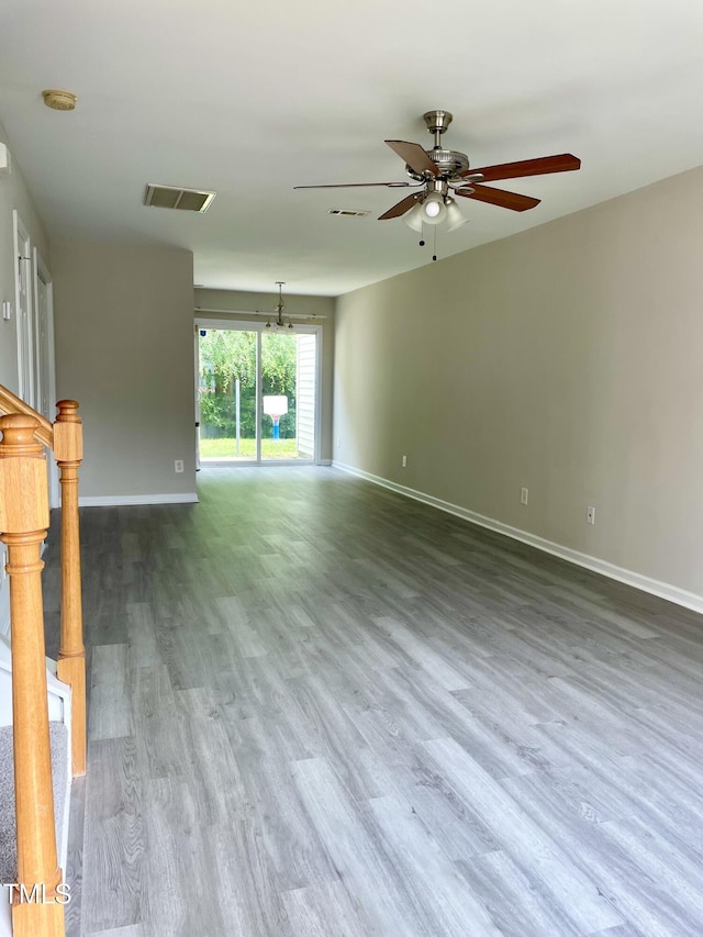 7832 Averette Field Dr, Raleigh, NC 27616 - unfurnished living room with a ceiling fan, wood finished floors, and baseboards
