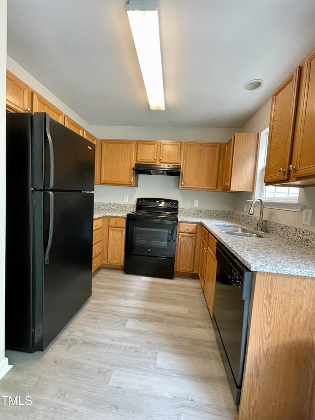 7832 Averette Field Dr, Raleigh, NC 27616 - kitchen featuring black appliances, a sink, under cabinet range hood, light wood finished floors, and light stone countertops