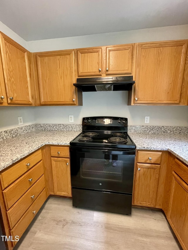 7832 Averette Field Dr, Raleigh, NC 27616 - kitchen featuring black electric range oven, extractor fan, light wood finished floors, and light stone countertops