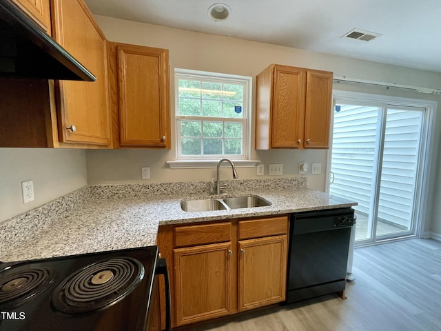 7832 Averette Field Dr, Raleigh, NC 27616 - kitchen with black appliances, a sink, under cabinet range hood, light wood-type flooring, and light stone counters