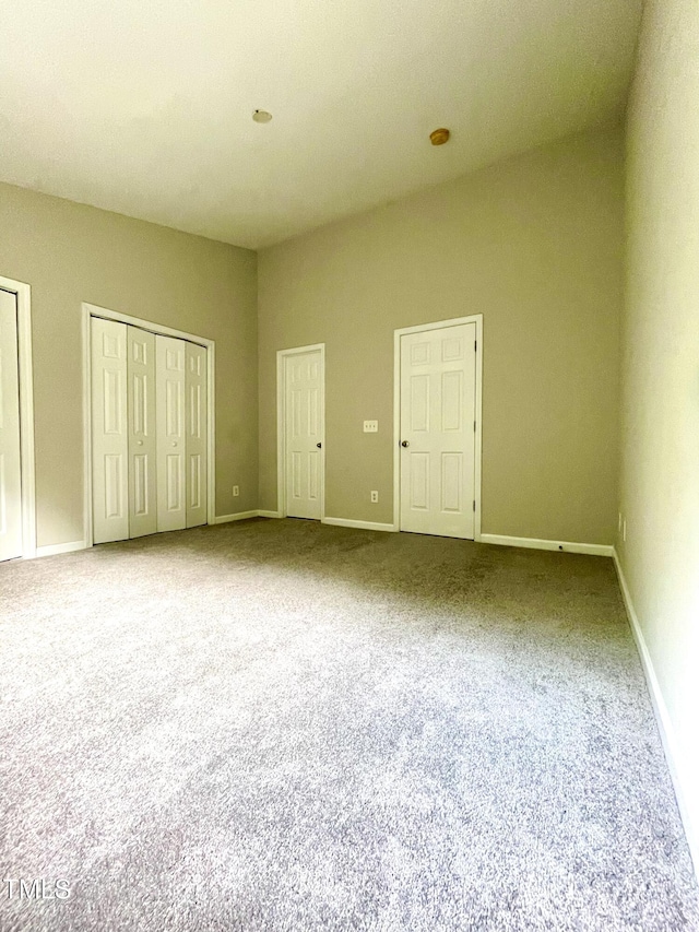7832 Averette Field Dr, Raleigh, NC 27616 - unfurnished bedroom with carpet flooring, multiple closets, and baseboards