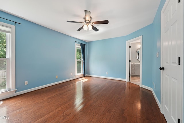304 Cayman Ave, Holly Springs, NC 27540 - unfurnished bedroom with multiple windows, wood finished floors, and baseboards
