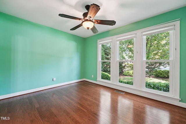 304 Cayman Ave, Holly Springs, NC 27540 - spare room featuring baseboards, dark wood-type flooring, and a ceiling fan