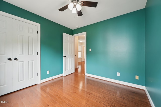 304 Cayman Ave, Holly Springs, NC 27540 - unfurnished bedroom with baseboards, wood finished floors, a closet, and a ceiling fan