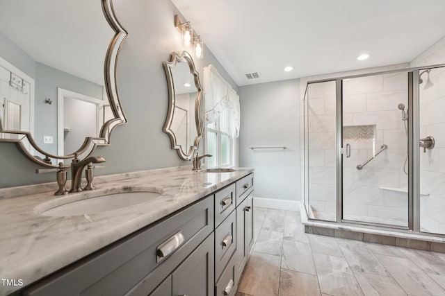 304 Cayman Ave, Holly Springs, NC 27540 - full bath with double vanity, a shower stall, recessed lighting, and marble look tile flooring