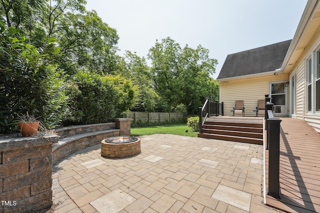 304 Cayman Ave, Holly Springs, NC 27540 - fenced backyard featuring a patio area, a wooden deck, and an outdoor fire pit