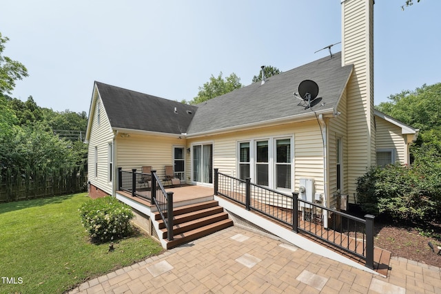 304 Cayman Ave, Holly Springs, NC 27540 - rear view of house featuring a yard, a patio area, a deck, a chimney, and a shingled roof