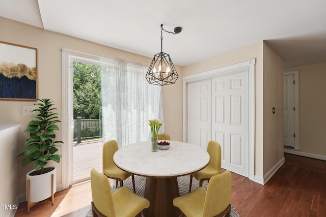 304 Cayman Ave, Holly Springs, NC 27540 - dining room featuring wood finished floors, baseboards, and a chandelier
