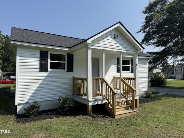 203 Hope St, Erwin, NC 28339 - view of front of home featuring roof with shingles and a front lawn