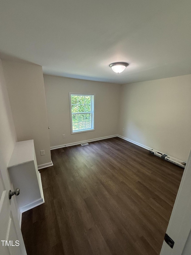 203 Hope St, Erwin, NC 28339 - unfurnished room with dark wood finished floors and baseboards