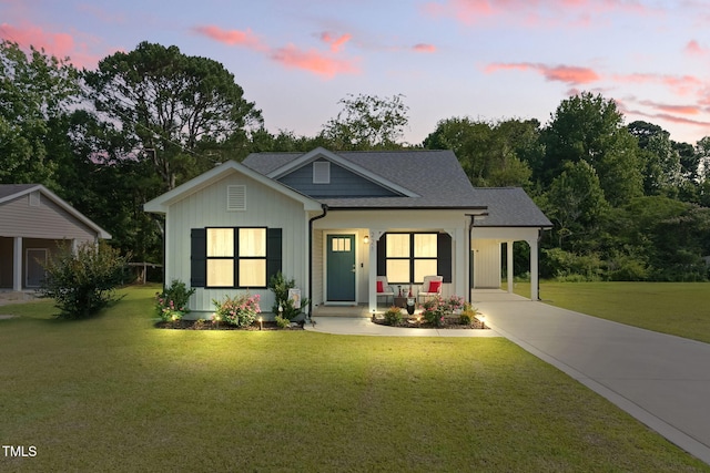 221 Moon Cir, Dunn, NC 28334 - modern inspired farmhouse featuring a front yard, driveway, board and batten siding, covered porch, and an attached carport