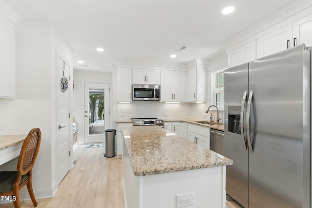 221 Moon Cir, Dunn, NC 28334 - kitchen featuring stainless steel appliances, a sink, a kitchen island, white cabinetry, and recessed lighting