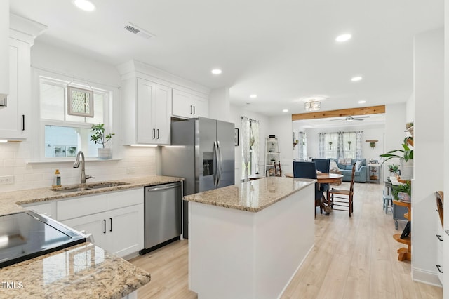 221 Moon Cir, Dunn, NC 28334 - kitchen with dishwasher, a sink, recessed lighting, plenty of natural light, and a kitchen island