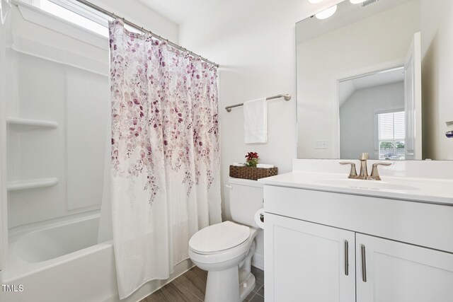 200 Cloud Berry Ln, Holly Springs, NC 27540 - bathroom featuring vanity, toilet, shower / bath combo with shower curtain, wood finished floors, and vaulted ceiling