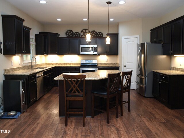 3650 Pleasants Ridge Dr, Wake Forest, NC 27587 - kitchen featuring appliances with stainless steel finishes, a sink, a center island, light stone counters, and recessed lighting