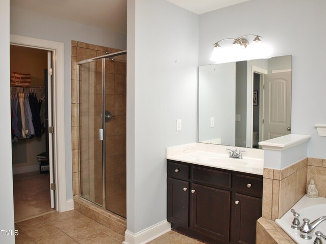 3650 Pleasants Ridge Dr, Wake Forest, NC 27587 - full bath with a stall shower, a walk in closet, vanity, tile patterned flooring, and a bath