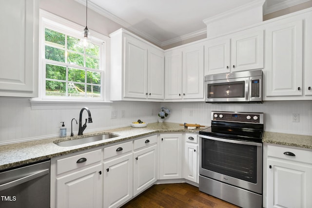 8201 Ivymount Way, Raleigh, NC 27613 - kitchen with appliances with stainless steel finishes, a sink, white cabinetry, and crown molding