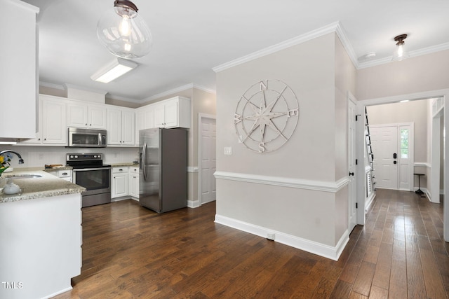 8201 Ivymount Way, Raleigh, NC 27613 - kitchen with appliances with stainless steel finishes, dark wood finished floors, white cabinets, a sink, and ornamental molding