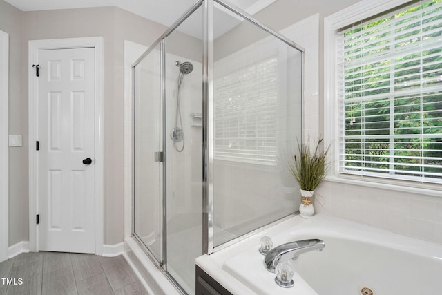 8201 Ivymount Way, Raleigh, NC 27613 - full bathroom featuring a shower stall, a jetted tub, and baseboards