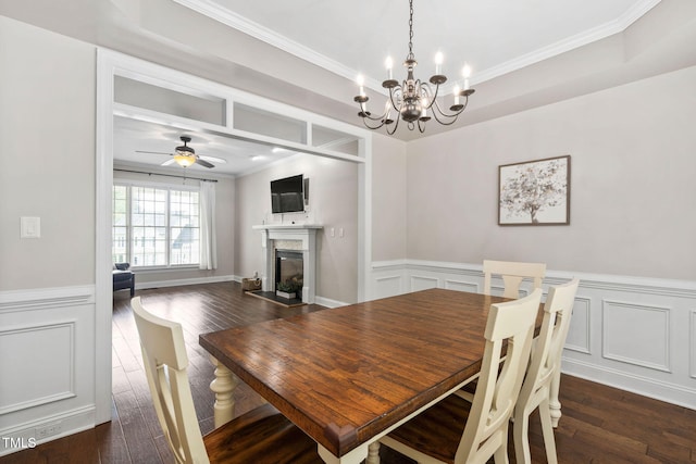 8201 Ivymount Way, Raleigh, NC 27613 - dining room with a chandelier, a fireplace, crown molding, dark wood-style flooring, and a wainscoted wall