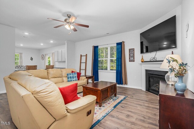 98 Panmure, Rocky Mount, NC 27804 - living room featuring a ceiling fan, wood finished floors, a glass covered fireplace, baseboards, and recessed lighting