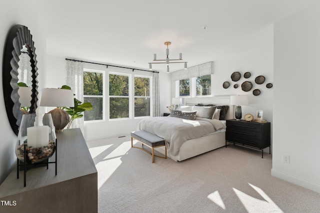 142 N White St # 100, Wake Forest, NC 27587 - bedroom with carpet flooring, baseboards, and a chandelier