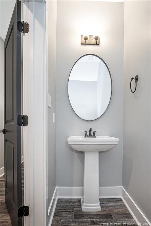 3029 Candlelight Dr, Fayetteville, NC 28311 - bathroom featuring baseboards, wood finished floors, and a sink