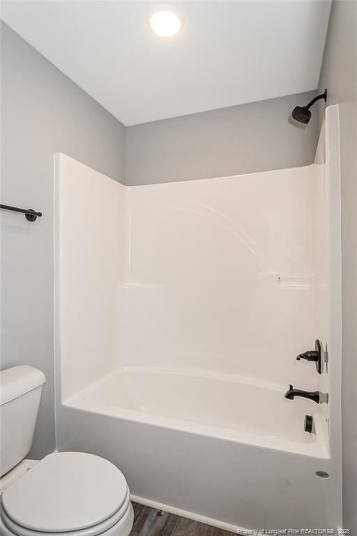 3029 Candlelight Dr, Fayetteville, NC 28311 - bathroom with toilet, wood finished floors, and washtub / shower combination
