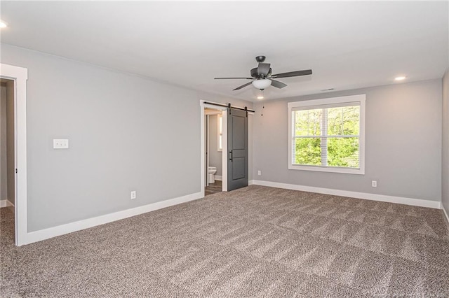 3029 Candlelight Dr, Fayetteville, NC 28311 - unfurnished bedroom featuring a barn door, carpet flooring, baseboards, and recessed lighting