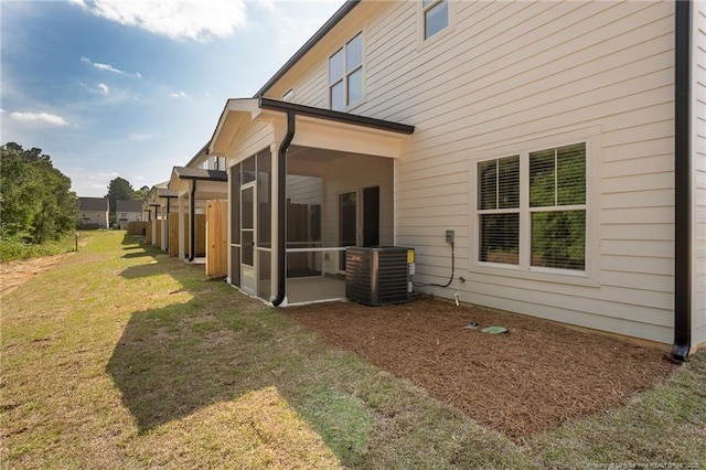 3029 Candlelight Dr, Fayetteville, NC 28311 - back of property featuring central AC unit, a sunroom, and a lawn