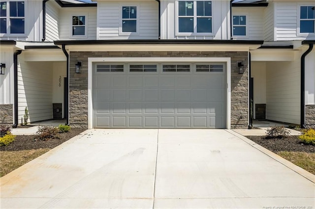 3029 Candlelight Dr, Fayetteville, NC 28311 - view of front of property featuring stone siding, a garage, and driveway