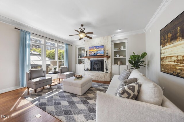 1006 Henny Pl, Raleigh, NC 27614 - living room with built in features, ornamental molding, wood finished floors, baseboards, and ceiling fan