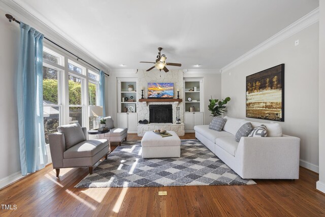 1006 Henny Pl, Raleigh, NC 27614 - living room with wood finished floors, built in features, ceiling fan, ornamental molding, and a stone fireplace