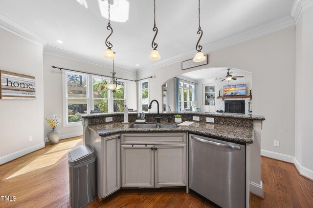 1006 Henny Pl, Raleigh, NC 27614 - kitchen featuring dishwasher, a sink, a ceiling fan, arched walkways, and crown molding