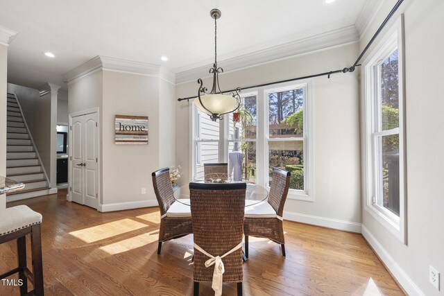 1006 Henny Pl, Raleigh, NC 27614 - dining room featuring crown molding, baseboards, light wood finished floors, stairs, and recessed lighting