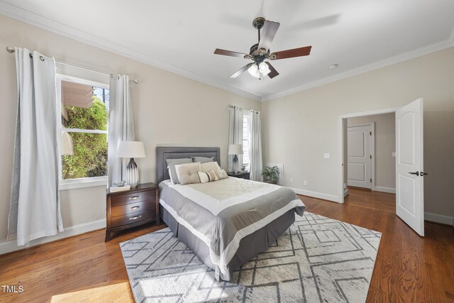 1006 Henny Pl, Raleigh, NC 27614 - bedroom with crown molding, multiple windows, baseboards, wood finished floors, and ceiling fan