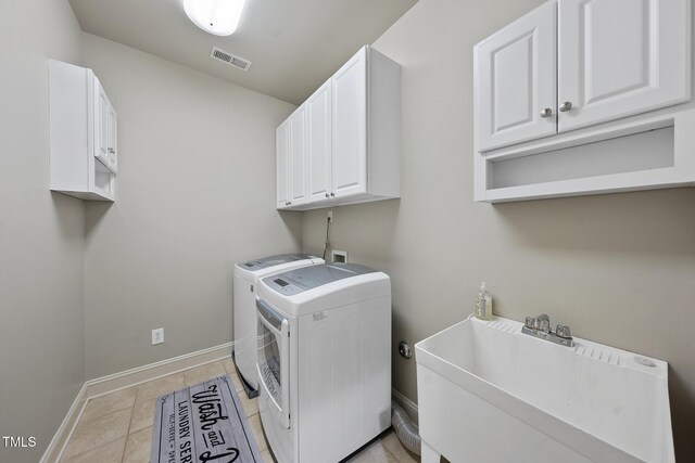 1006 Henny Pl, Raleigh, NC 27614 - laundry room with washing machine and dryer, cabinet space, baseboards, and light tile patterned floors