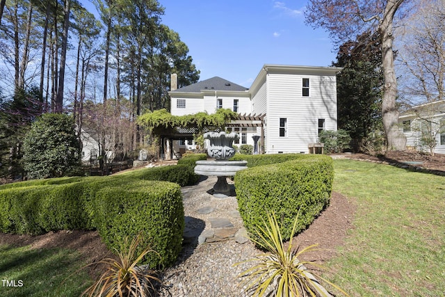 1006 Henny Pl, Raleigh, NC 27614 - back of house with a pergola and a chimney